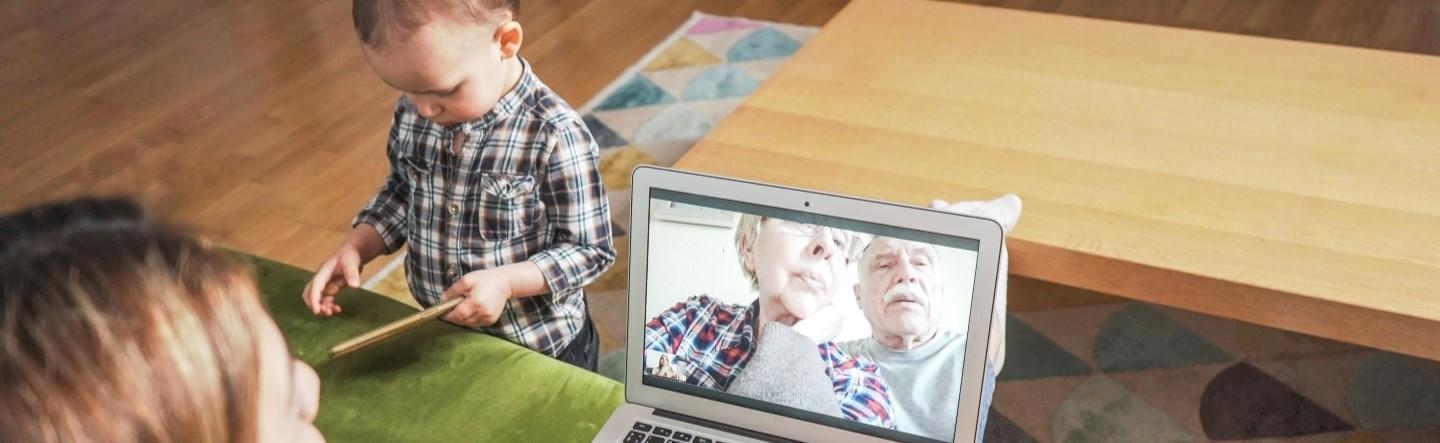 woman with baby video chatting with her older parents