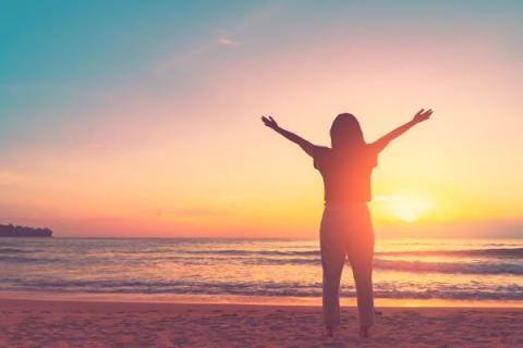 person on the beach at sunset