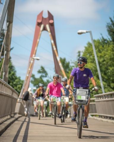 employees riding bikes on the DeFazio bridge