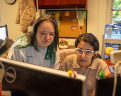 staff collaborating at a computer