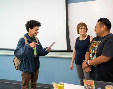 instructor talking with two students