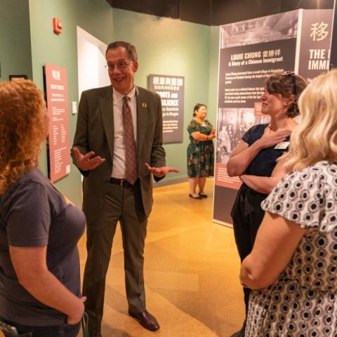 President Karl Scholz talking with three employees